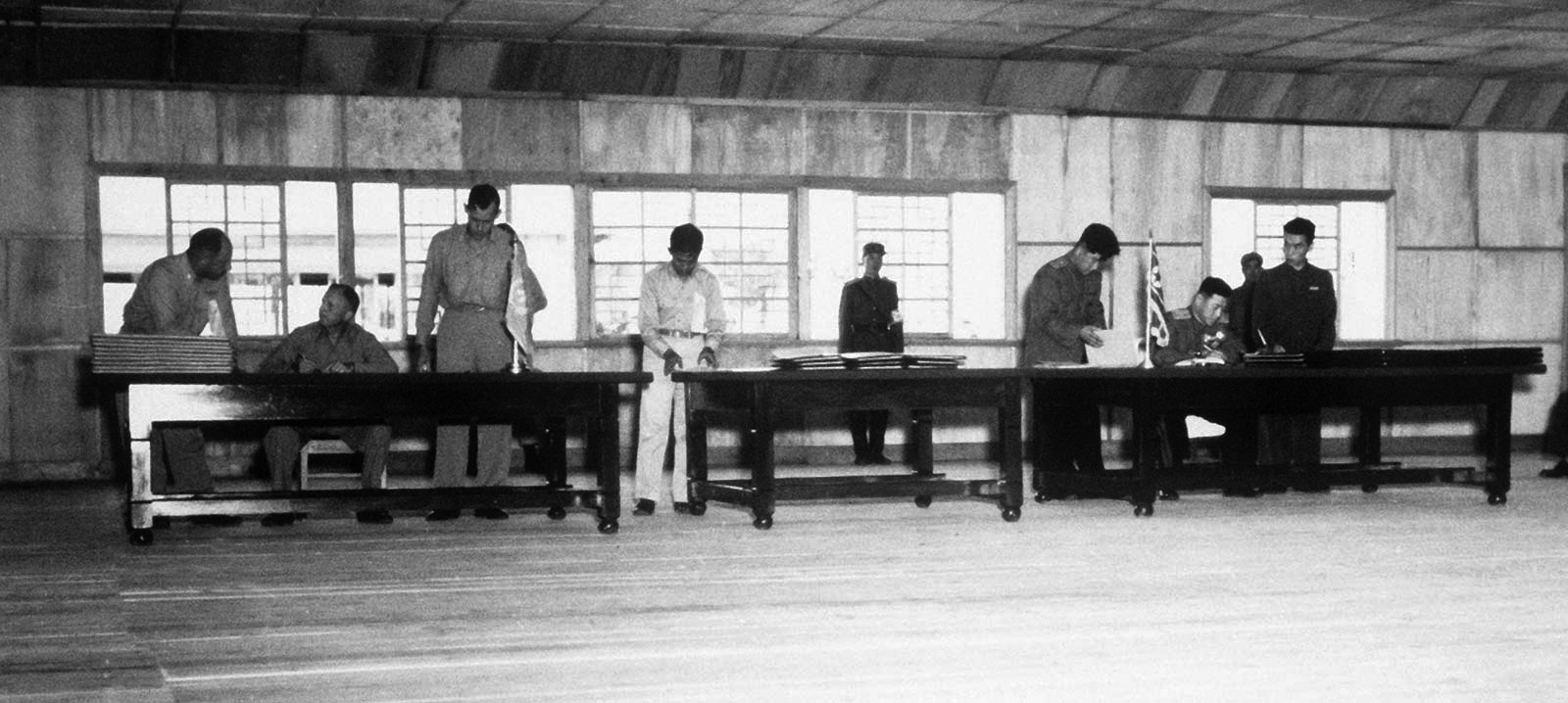 A signing ceremony for the armistice agreement held at Panmunjom on July 27, 1953 at 10:00 a.m. The person sitting on the left desk is William K. Harrison Jr., the chief delegate of the UN forces The person sitting on the right desk is Nam Il, the chief delegate of the Communist Army